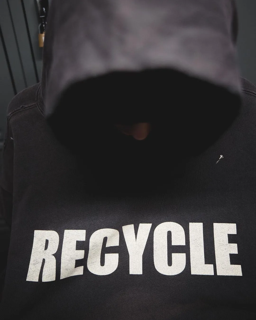 GALLERY DEPT. 90'S RECYCLE HOODIE WASHED BLACK 90'S washed hoodie with distressed eco-friendly slogans. Washed black S-XL. Ready-made garments are washed and dyed again. Multiple spots throughout the body are spray-faded. The ribs are cut and worn.